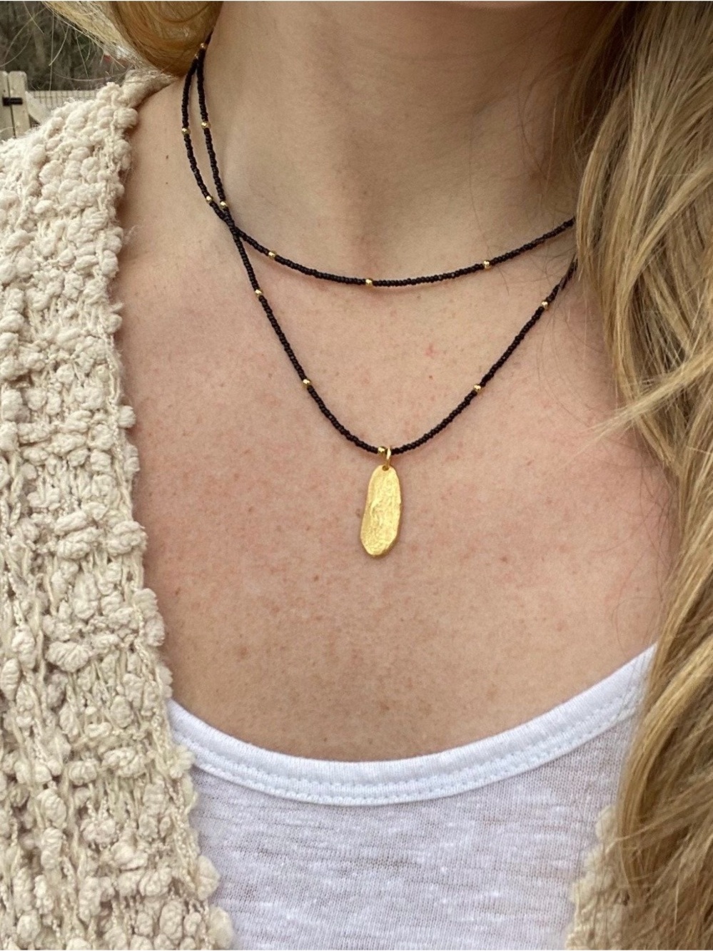 Double Strand Black Beaded Necklace with Gold Oval Pendant